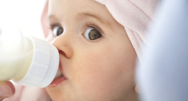 cute baby drinking bottle weaning night feeds