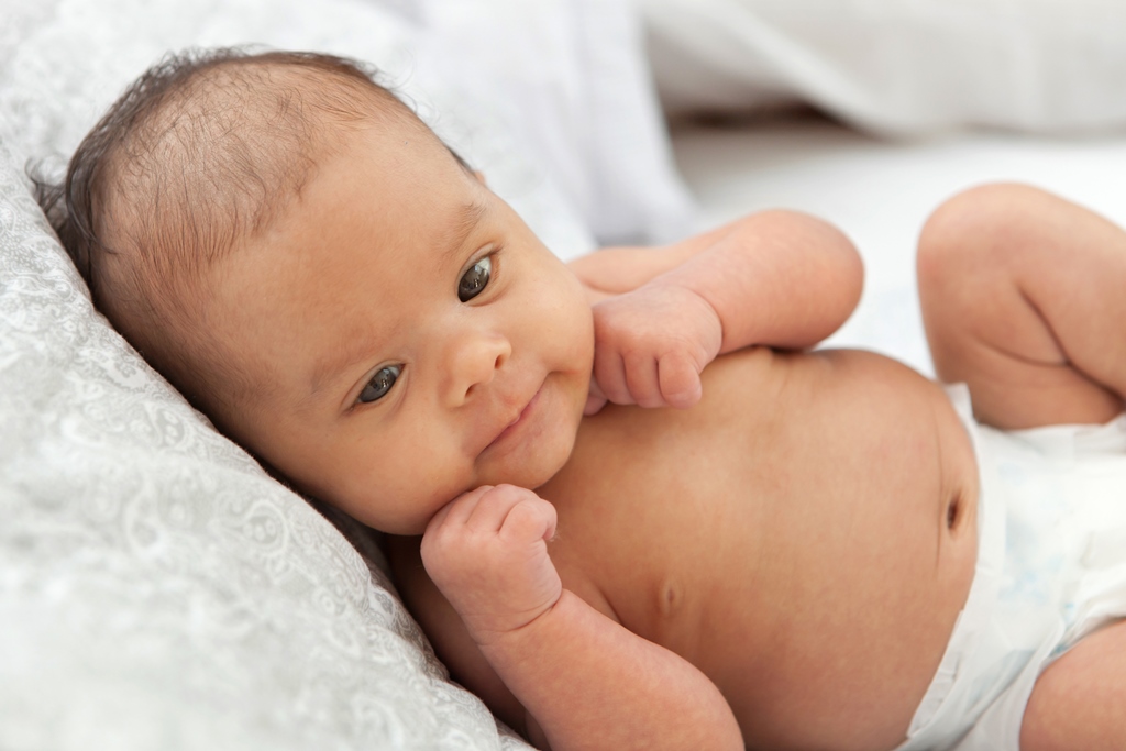 cute newborn in diaper on schedule