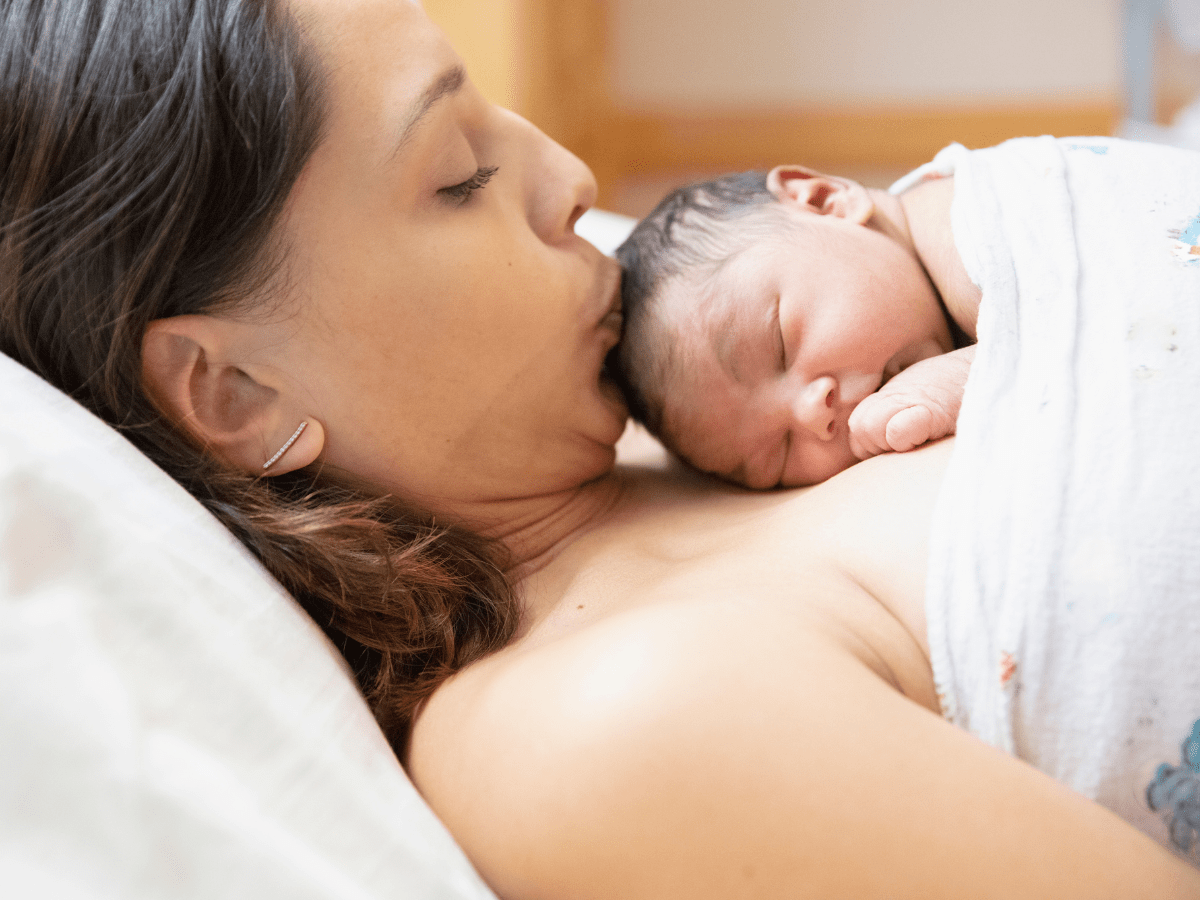 mom getting newborn baby to sleep at night